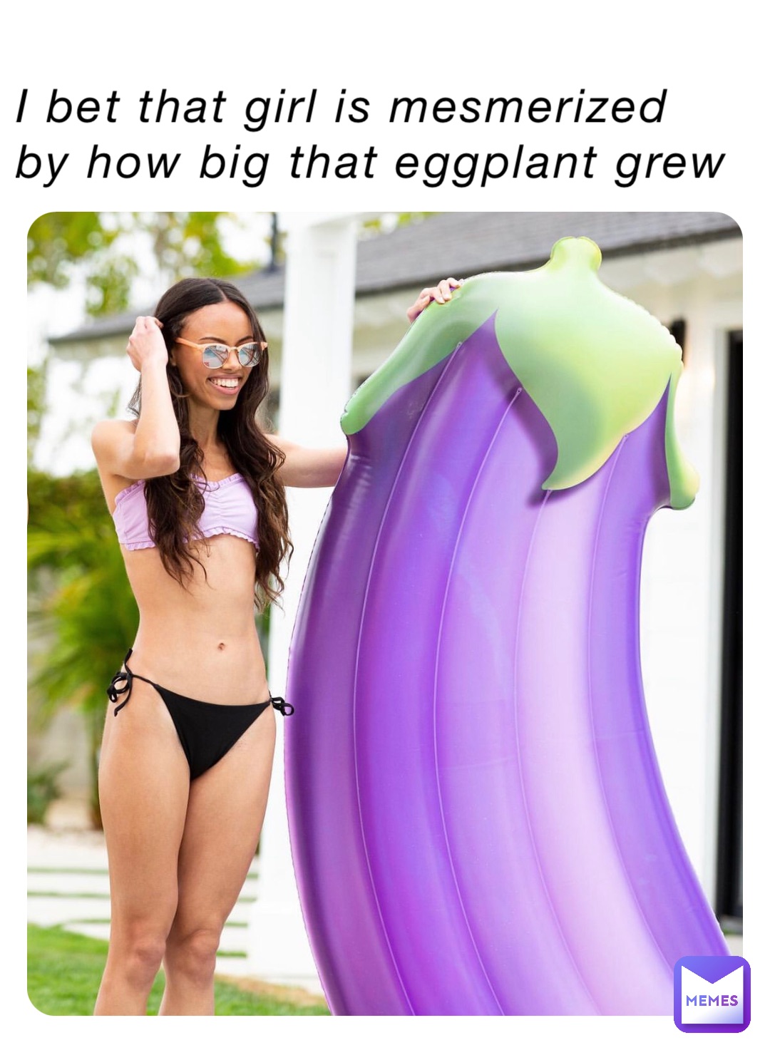 I bet that girl is mesmerized by how big that eggplant grew